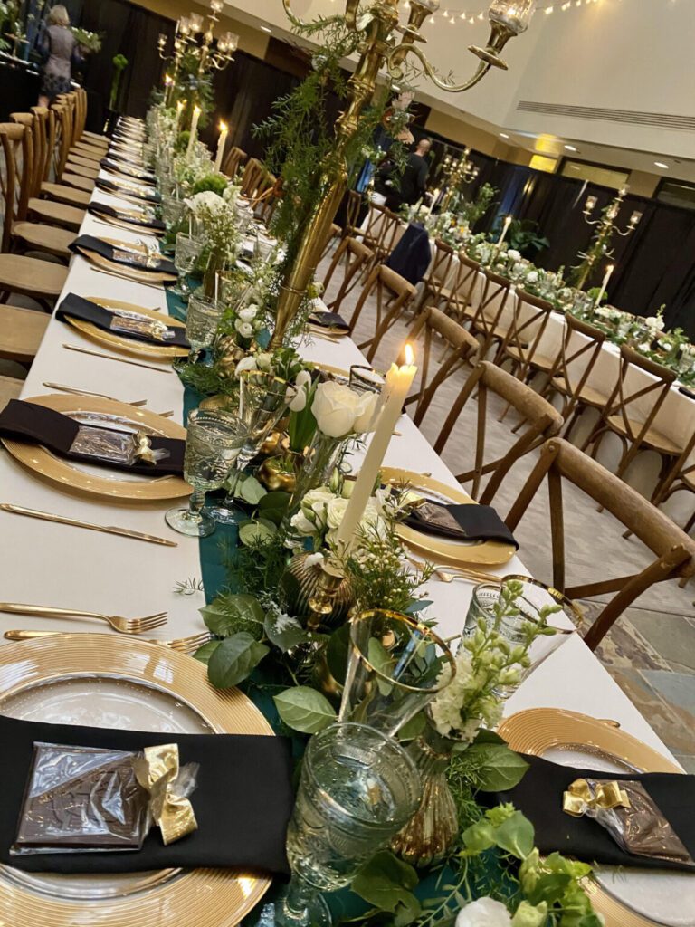 A long table with many plates and candles