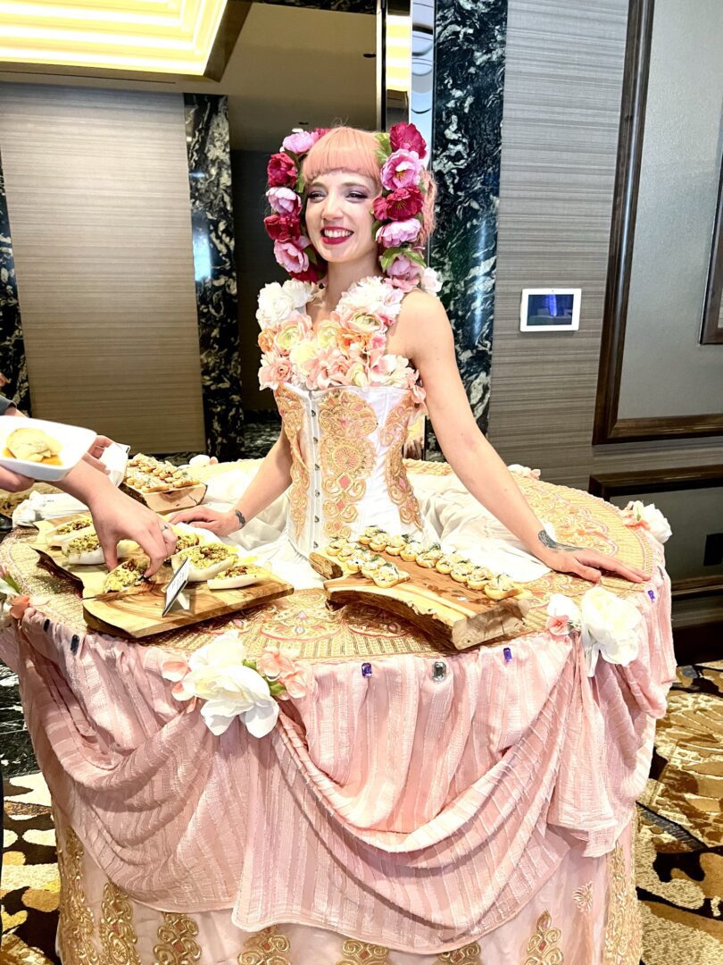 A woman in costume sitting on top of a table.