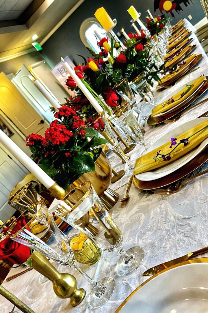 A table set with plates and candles for a party.