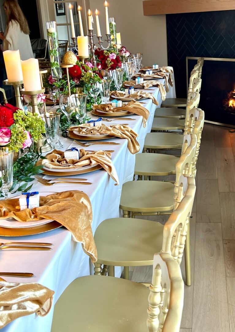 A long table with many plates and candles on it