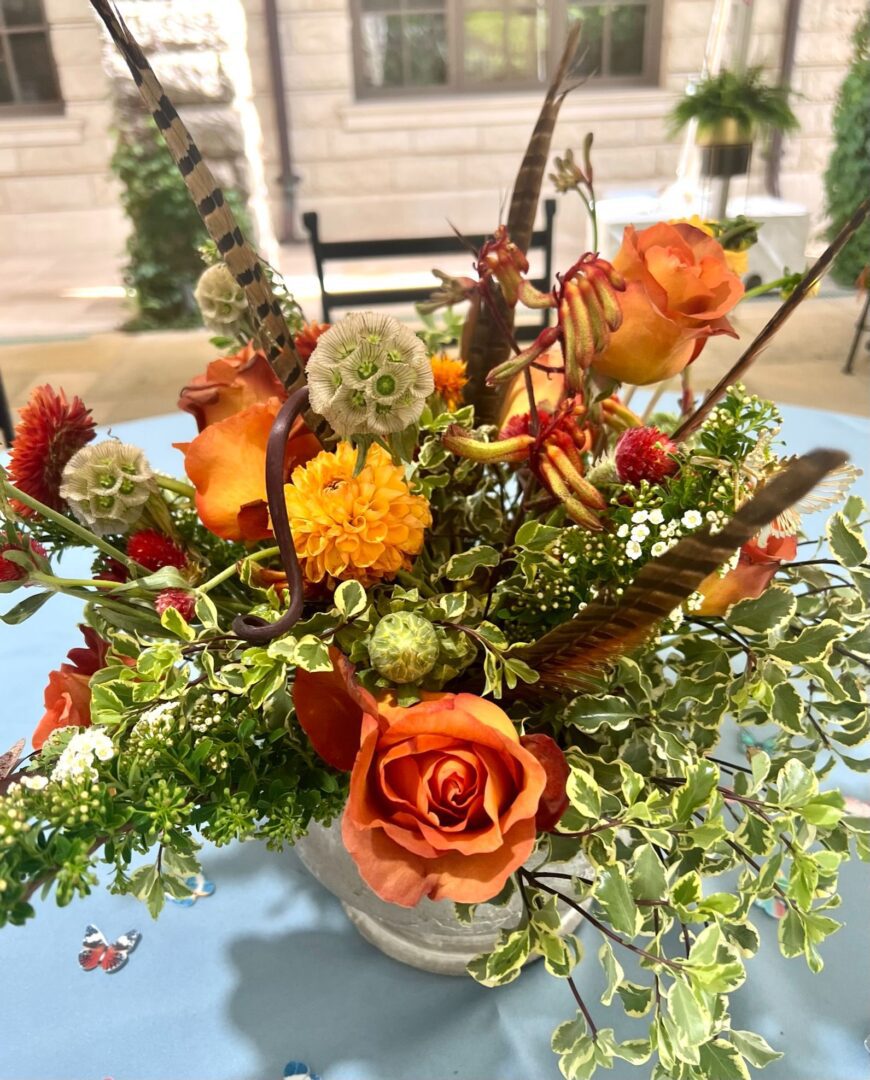 A table with flowers and leaves in it