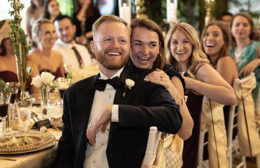 A man and woman posing for the camera at an event.