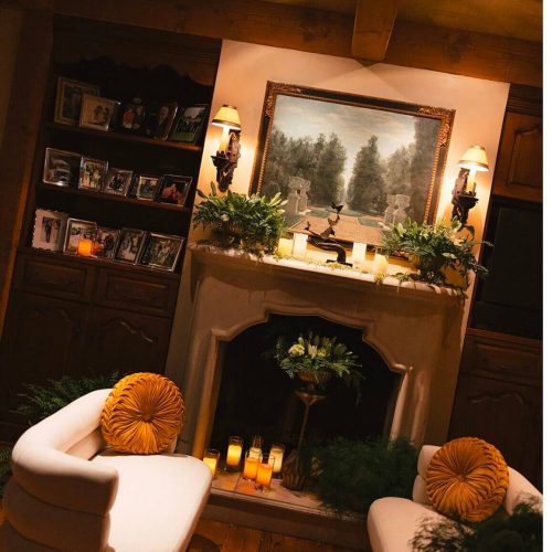 Cozy living room with a fireplace and warm lighting.