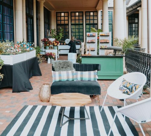 Elegant outdoor seating area with striped cushions and a bar setup.