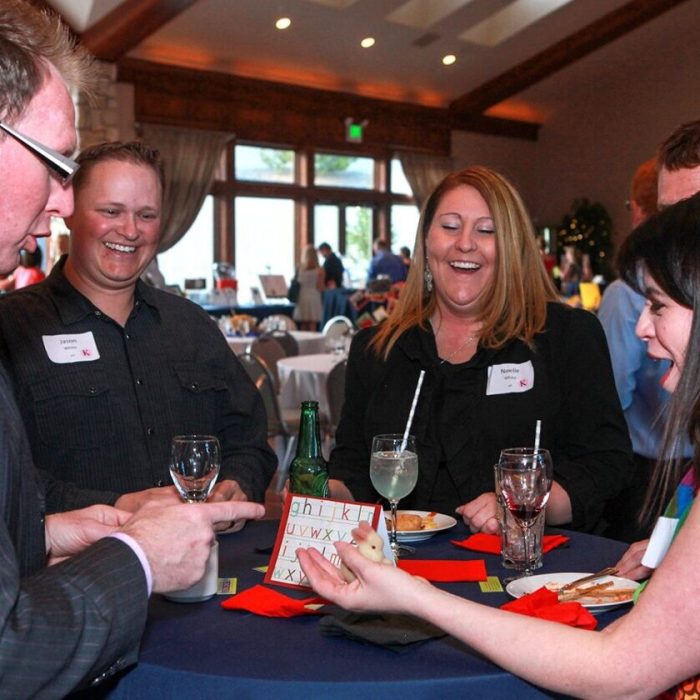 People enjoy a lively card game at a social gathering.