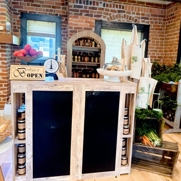 Cozy indoor garden corner with chalkboard signs and rustic decor.