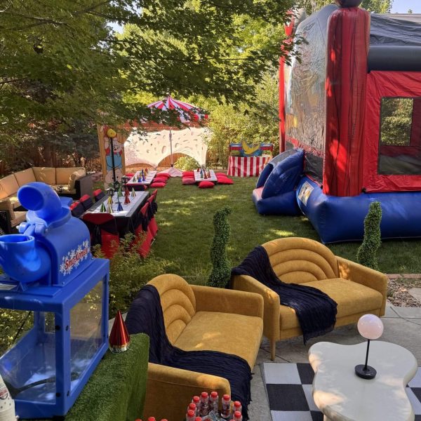 Outdoor party setup with a bounce house and seating area.